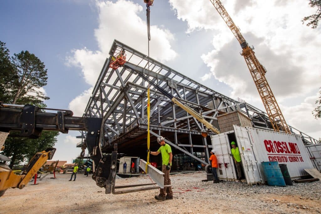 Crossland team members install the beam.