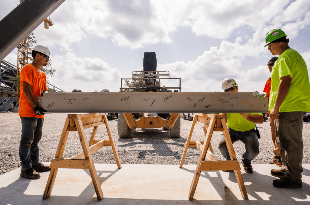 Crossland team members install the beam.